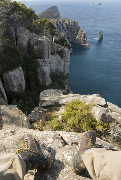 taking a break on a long walk to enjoy the view of cape hauy, tasman peninsula