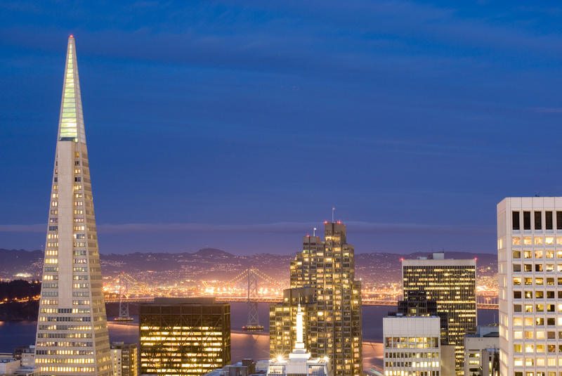 colourful cityscape of san francisco financial district and the bay bridge at night