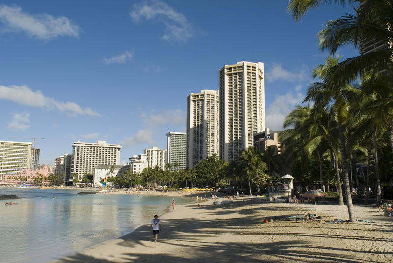 swimming lagoon and beach front lined with hotel towers, waikiki beach honolulu, hawaii