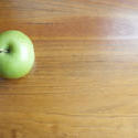 7025   Green apple on school desk