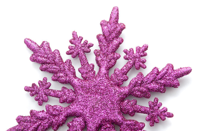 Pink snowflake Christmas ornament with textured glitter finish on a white background