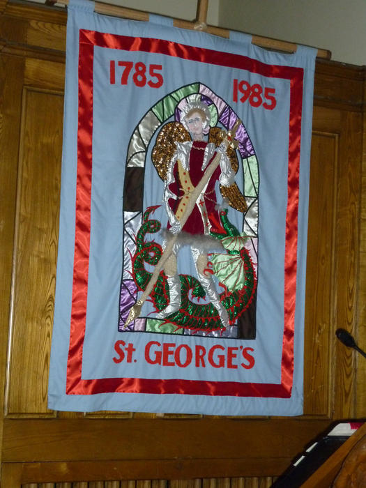 Colourful centenary textile banner of St George slaying the dragon in St George's Church, Sydney, Nova Scotia