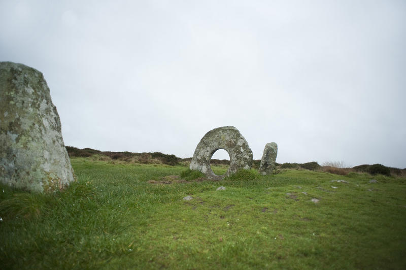 Men-an-tol monument Cornwall is a formation of three upright granite stones with the centre one being a rare round holed stone dating from prehistoric times