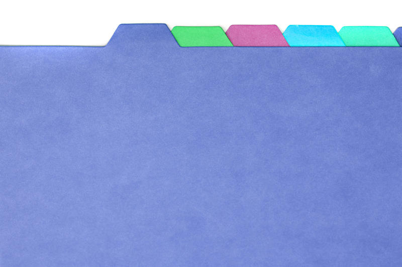 Blank multicoloured cardboard folder dividers with tabs for organising and filing documents