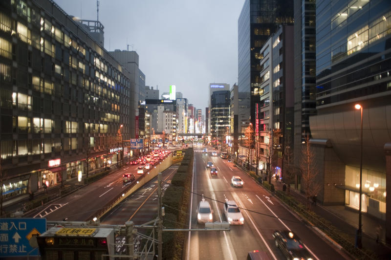 traffic and bright neon signs, evening in downtown Tokyo, Japan