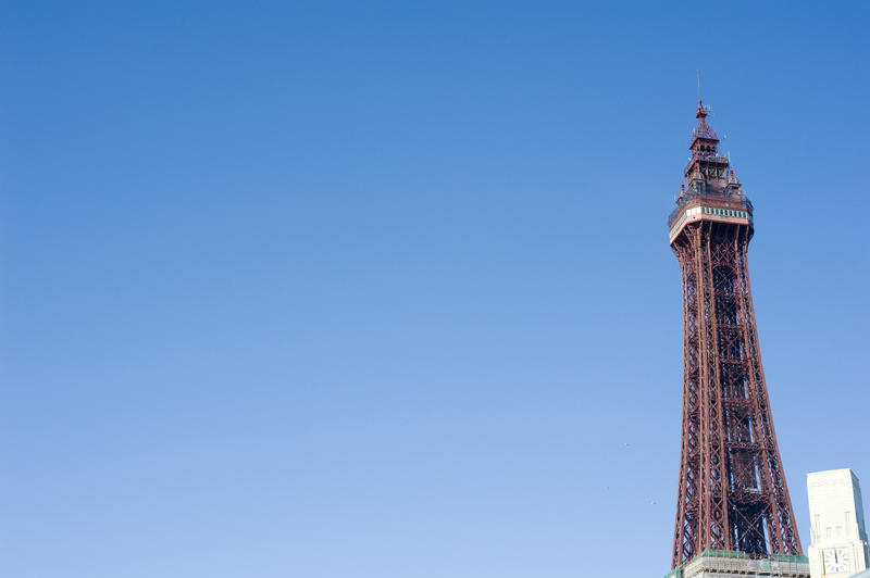 Top of the giant steel structure of the Victorian Blackpool Tower against blue sky with copyspace at Blackpool, Lancashire, England