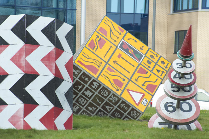 Colourful geometric roadsign sculptures by Pierre Vivant on the Magic Roundabout, Splott, Cardiff, Wales