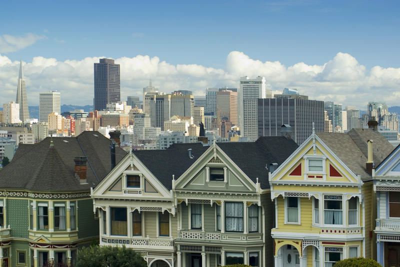 colourful houses known as Painted Lady at Alamo square with the san francisco city skyline behind - not property released