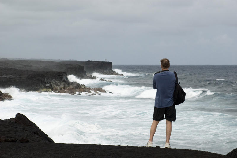 taking a photo of the rugged big island coastline