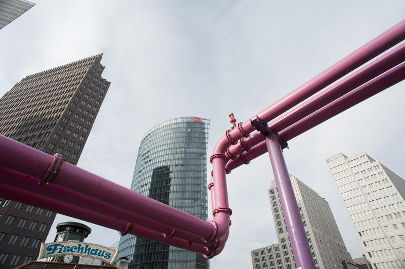 a city skyline with several large water pipes above ground