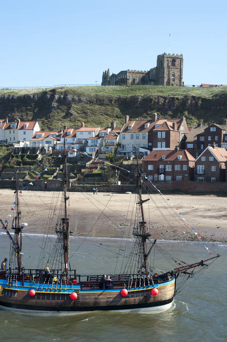 Bark Endeavour tourist cruise in the full size scale model replica of Captain Cooks famous ship passing Tate Hill and Whitby on the Yorkshire coast