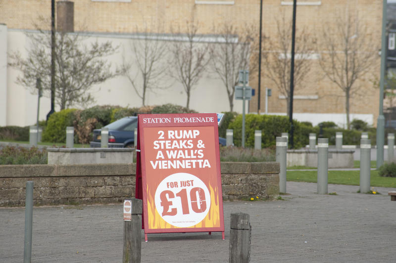 A-frame advertising board for a cheap meal of rump steak and icecream for two standing in a street
