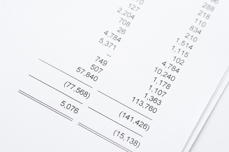Close up Summary of Accounts Reports Printed on White Papers Placed on the Table.