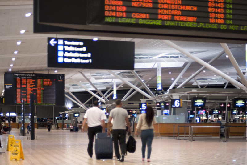 Interior View or Airport Terminal with Travelers Carrying Luggage