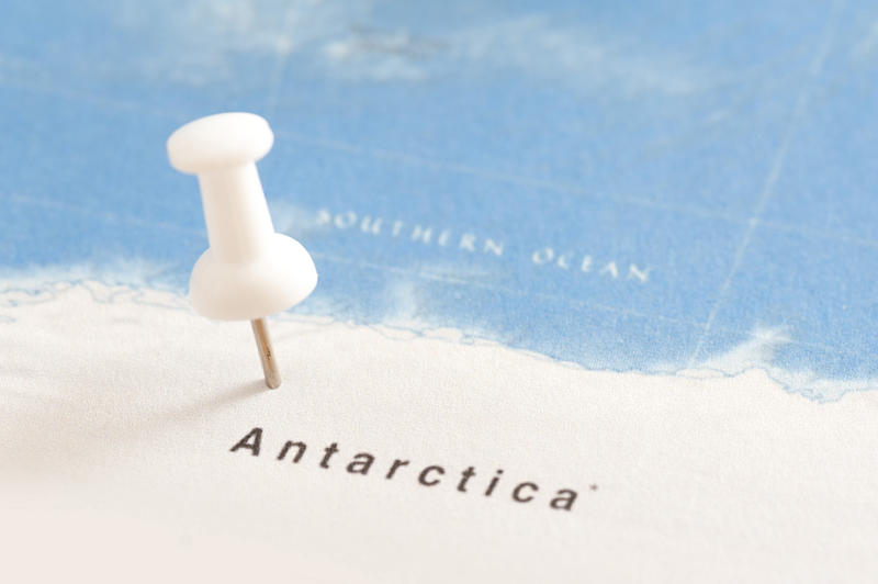 Close Up of White Thumb Tack Location Marker Inserted in Map of Antarctica near Southern Ocean