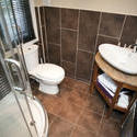 10657   Interior of a bathroom tiled in brown