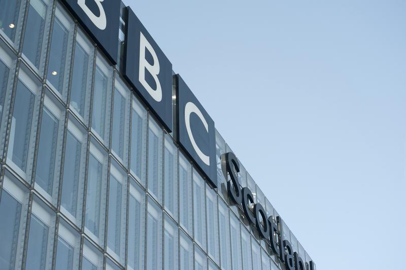BBC Scotland office building and broadcasting studios, low angle view of the front facade with the signage on top