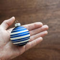 11684   Man holding a blue Christmas bauble