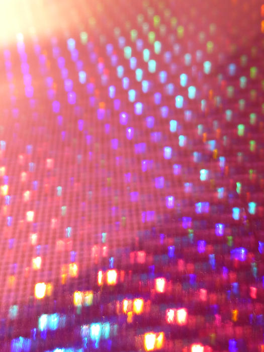 a reflective hologram background featuring vivid spots of colour