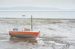 7744   Small fishing boat at low tide
