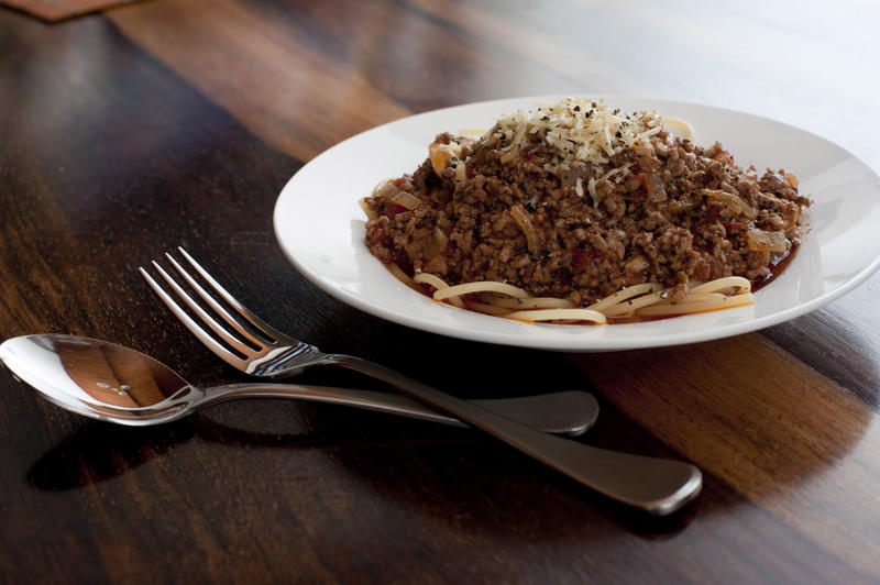 Serving of spaghetti Bolognese or Bolognaise topped with minced beef cooked in a tomato base
