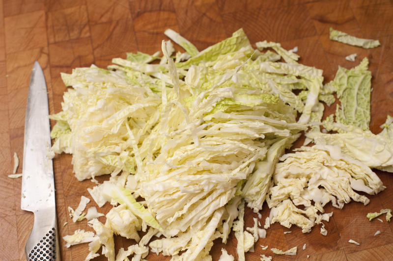 Finely chopped cabbage on a kitchen counter ready to be cooked as a vegetable accompaniment or turned into a cole slaw salad