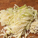 10503   Finely chopped cabbage on a kitchen counter