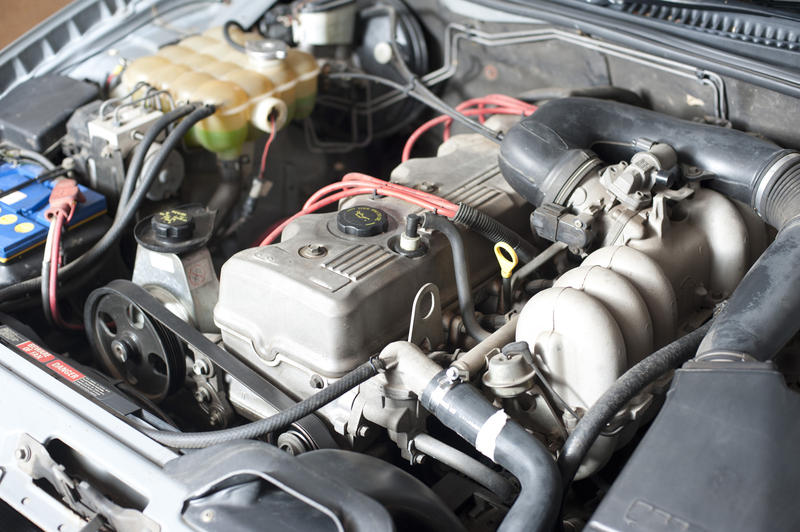 Close Up of Car Engine Under Hood of Car