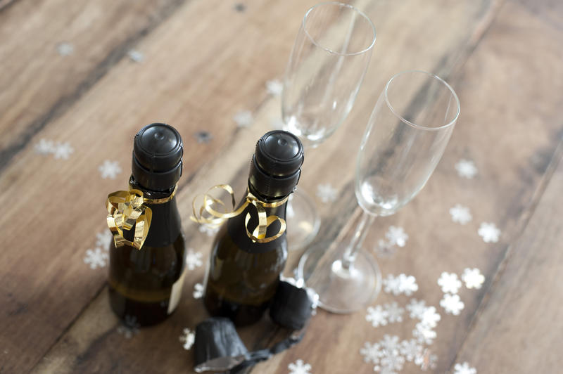 individual bottles of champagne for two people wrapped in gold ribbon