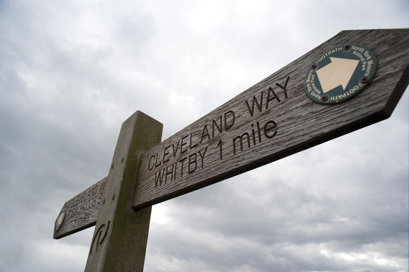 Cleveland Way signpost indicating the route of the Cleveland Way path that meanders across the scenic cliffs and headlands of the North Yorkshire coastline