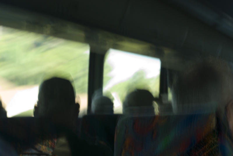 Abstract scene from a tour bus of the surreal blurred silhouettes of the passengers in their seats enjoying a sightseeing tour