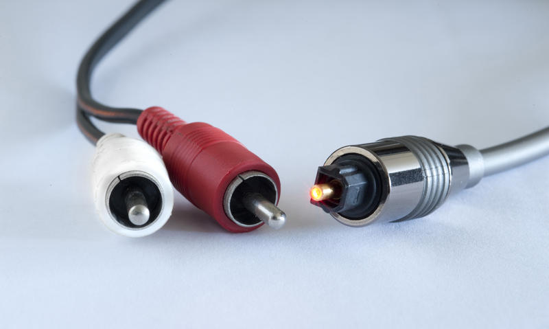 conceptual image of analog audio cables alongside a digital audio connection