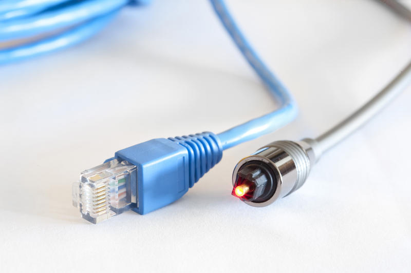 Close up Blue Copper and Silver Optical Cables for Telecommunication on White Table