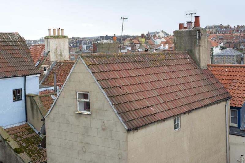 Traditional red tiled cottage roof with a steep pitch on an English house in Whitby, Yorkshire