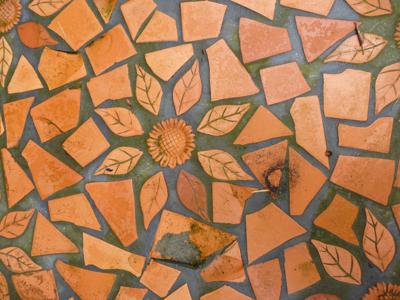 Looking Down at Detail of Leaf and Flower Shaped Terracotta Tiles as Part of Architectural Mosaic Design