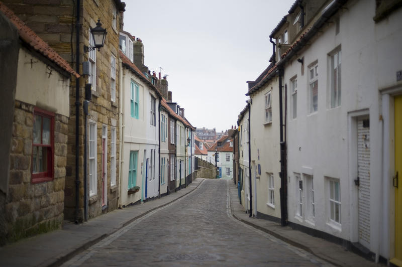 Quaint narrow Henrietta street in Whitby which leads from the edge of town to the 199 steps going up to St Marys Church on Tate Hill