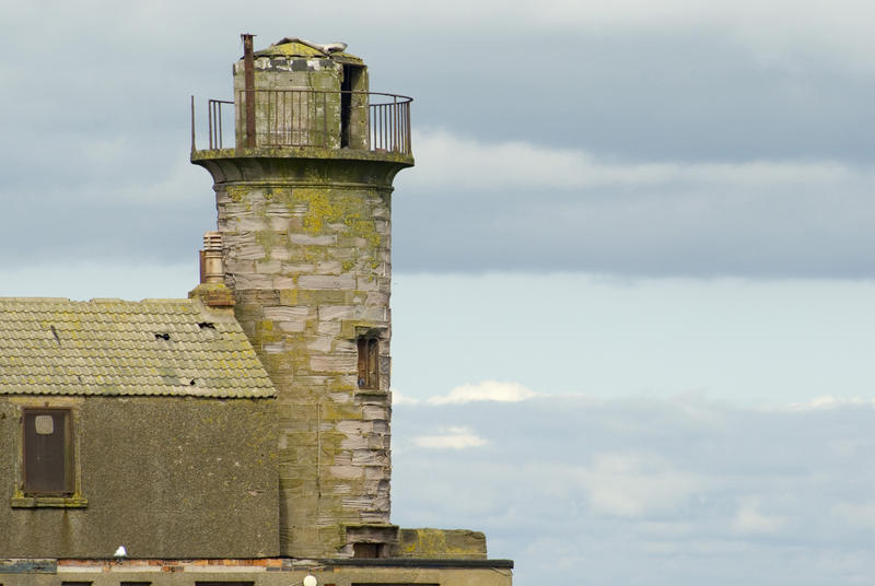 Old historic derelict stone harbour beacon at Whitehaven harbour in Cumbria