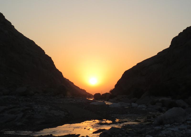 <p>Sun set through desert mountain<br />
</p>