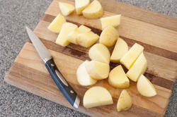 10607   Fresh Slices of Uncooked Potatoes on Wooden Board