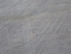 10916   Tyre treads in the sand of a dirt track