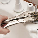 10164   Man repairing a broken faucet or tap