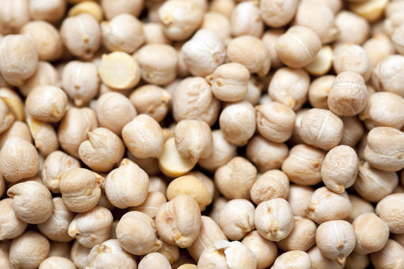 Background of dried chickpeas, a legume and one of the earliest cultivated vegetables very high and protein and a staple in vegetarian cuisine