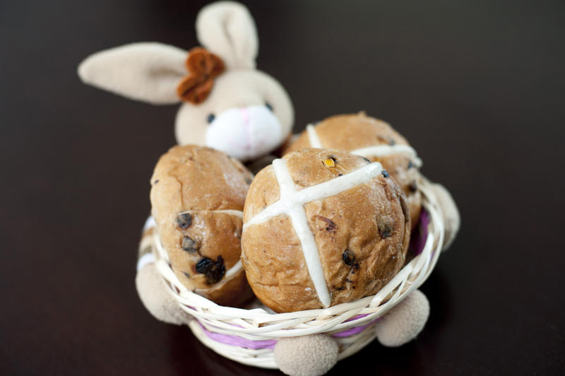 Close up Homemade Tasty Buns in an Easter Basket with Bunny, place on Top of the Table.