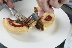 10476   Man eating a tasty meat pie