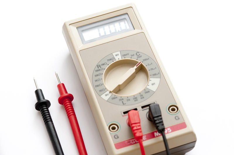 Electrical handheld meter with positive and negative cables for checking electrical circuits and wiring to test electornic components
