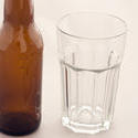 10442   Empty glass with a bottle of beer