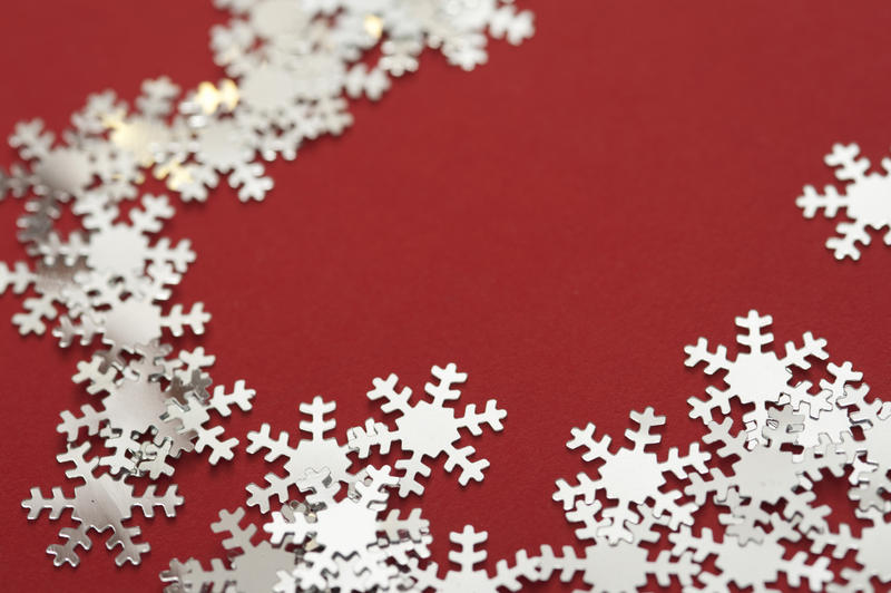 Close up Man Made Snow Flakes Border Design on red Background.