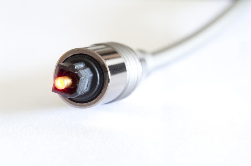 Close up Glowing Silver Fiber Optical Cable for Telecommunications Isolated on a White Background