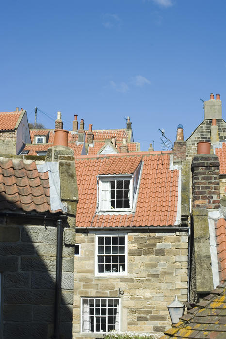 Fishermans cottages with their large cottage paned windows in the quaint fishing village of Robin Hoods Bay in Yorkshire