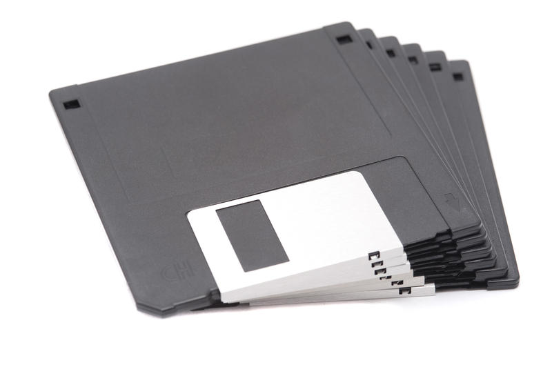 Stack of unused magnetic floppy discs for storing information from a computer isolated on white